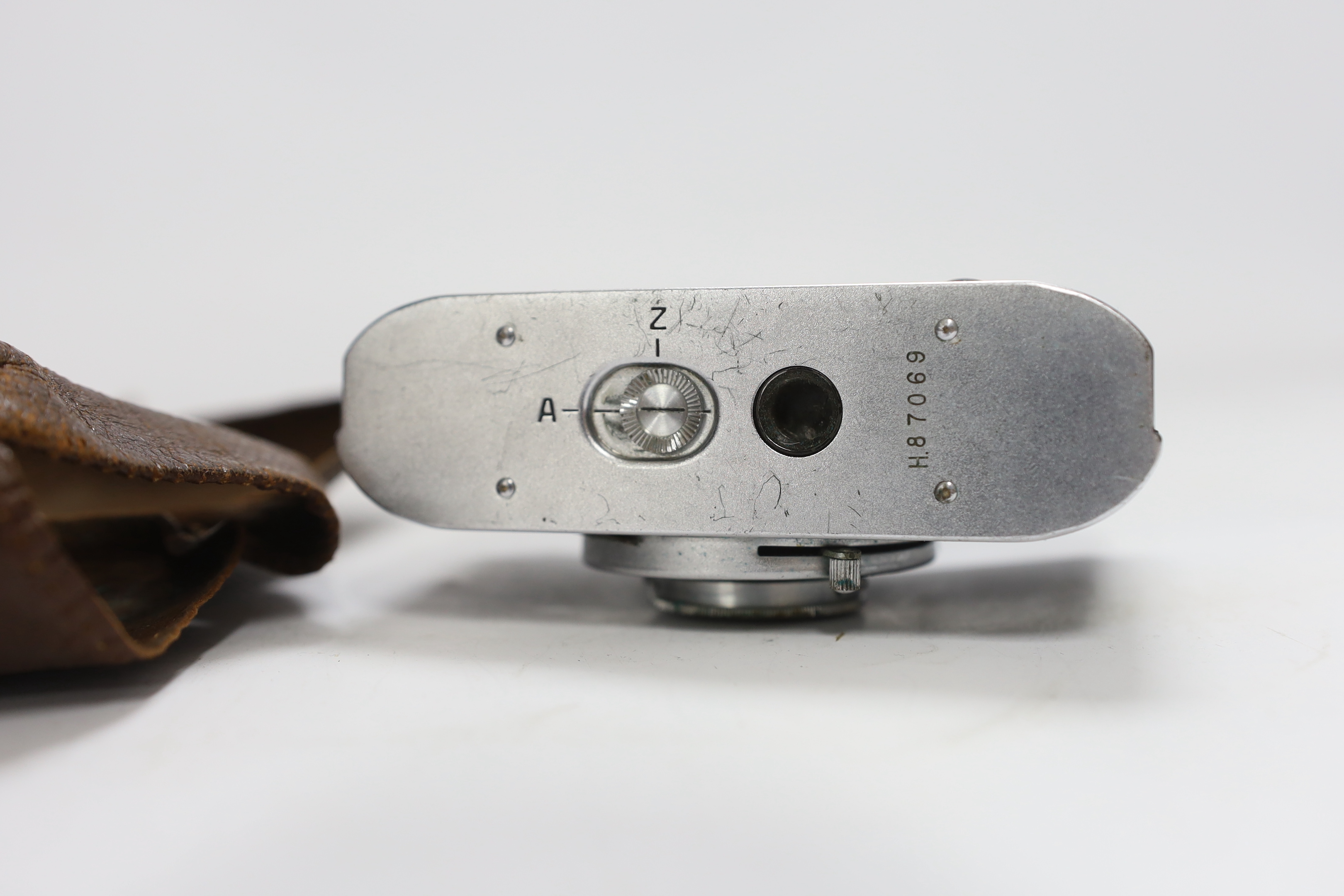 A 1940s Zeiss Ikon Tenax I compact camera, serial no.H87069, in the remains of a leather case